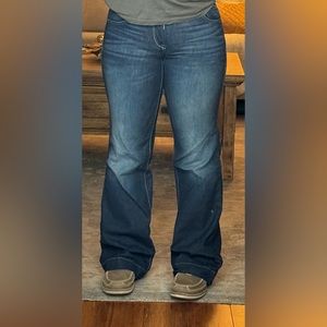 Mid rise boots cut ariat jeans.